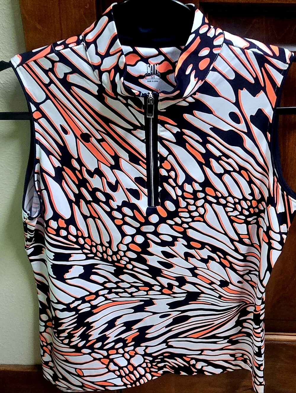 Tail sleeveless 1/4 zip sleeveless top. Bright coral orange, navy & white. MED.